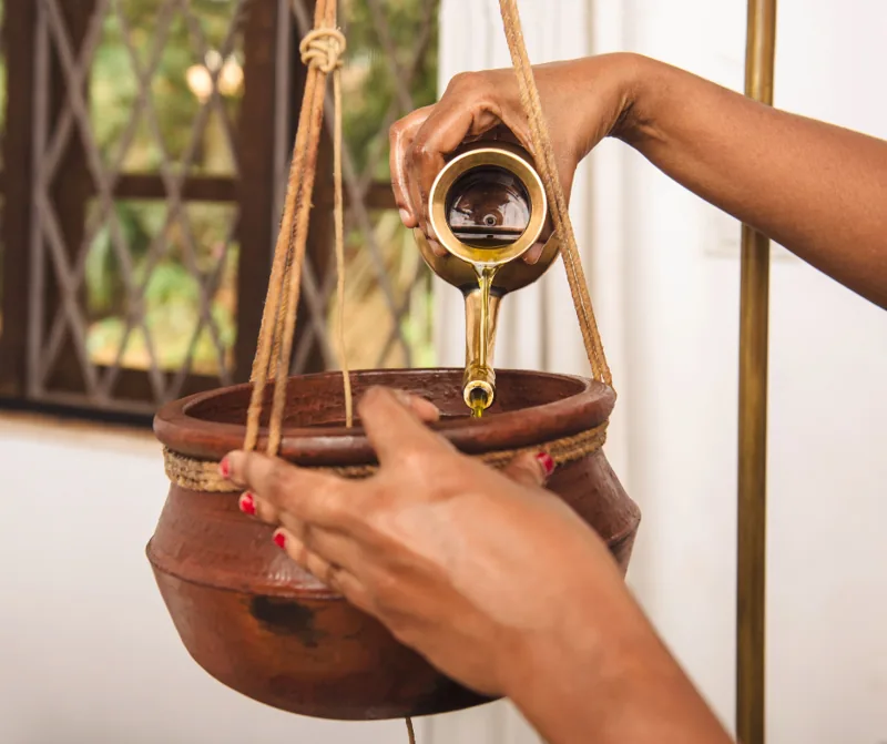 Shirodhara treatment with a copper vessel