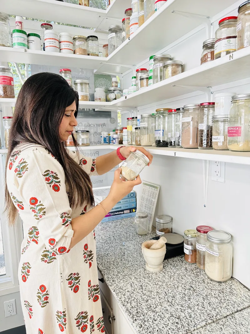 Preeti Gupta preparing an Ayurvedic blend in the clinic